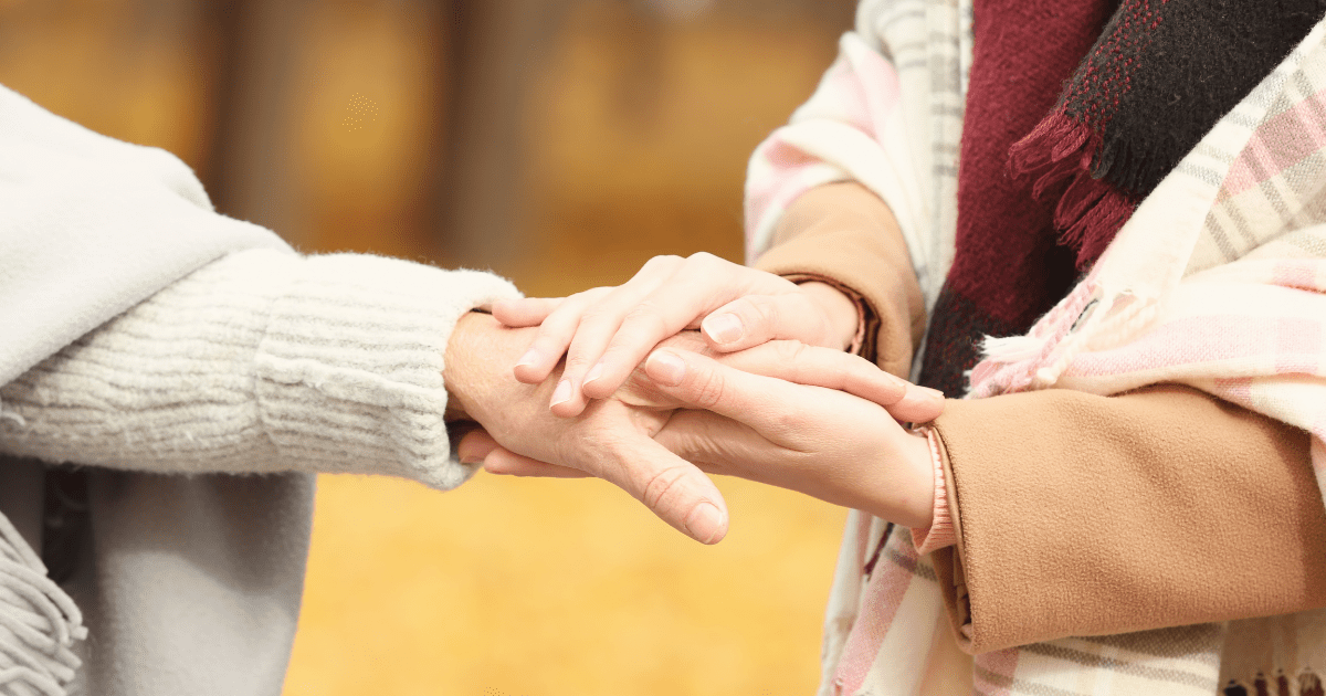 Two people holding hands in a circle.