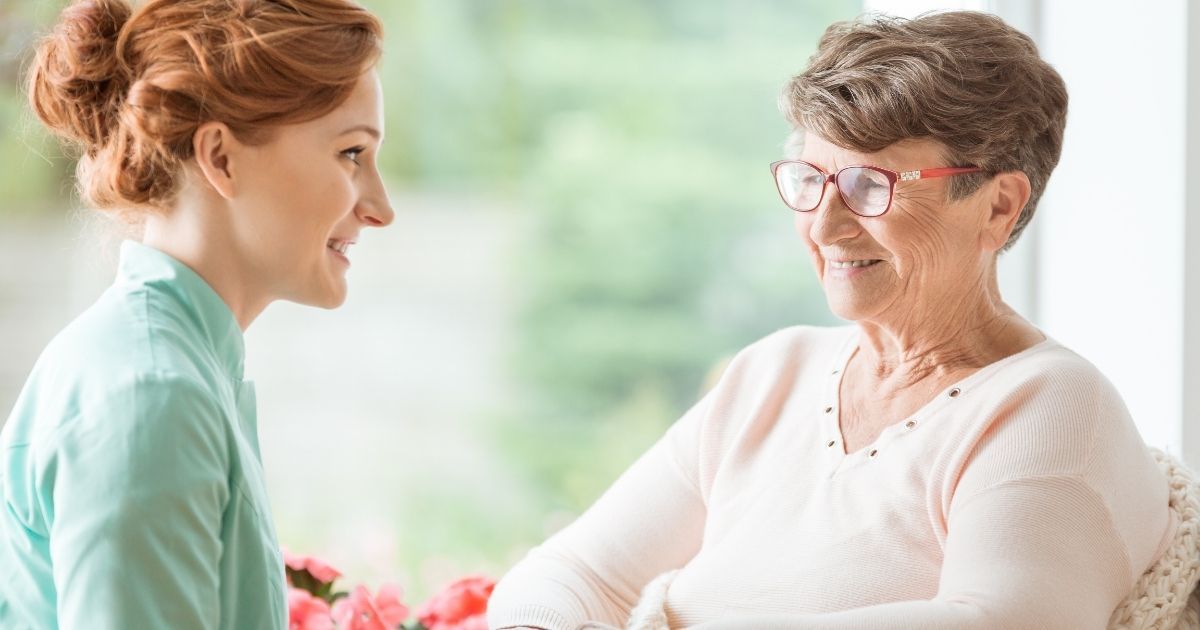 A woman and an older lady sitting at a table.