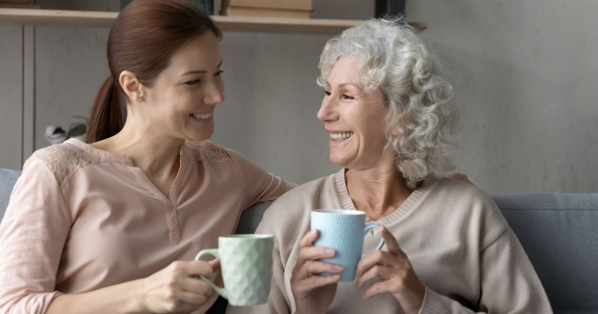 Two women are drinking coffee together.