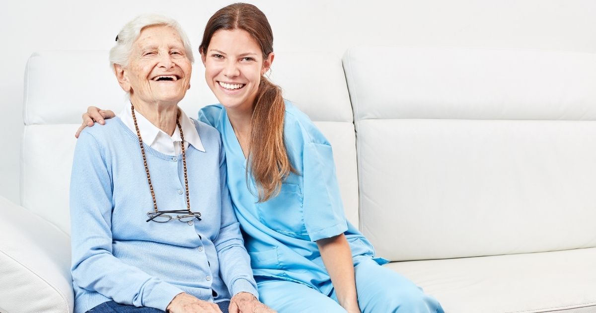 A woman and an old lady sitting on the couch