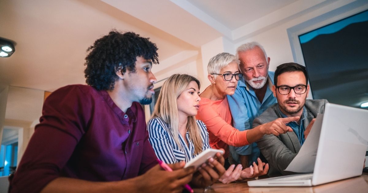 A group of people sitting around a table.